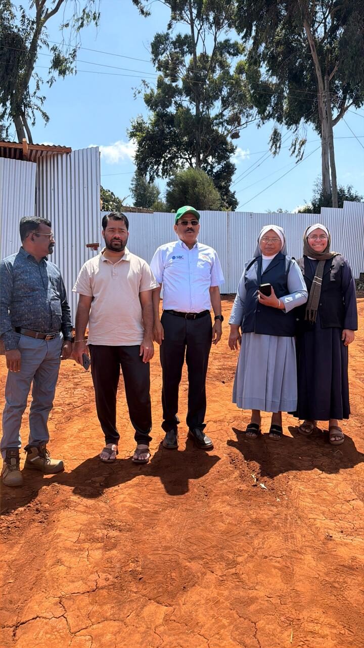 The team and Sisters at the site office