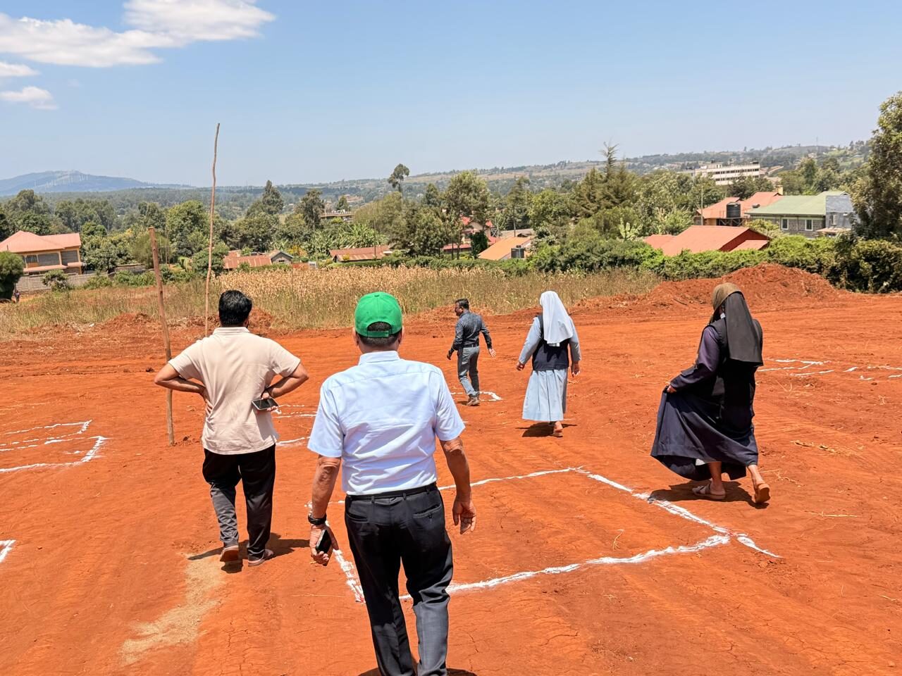 Walking the marked-out plot with Nairobi's hills beyond